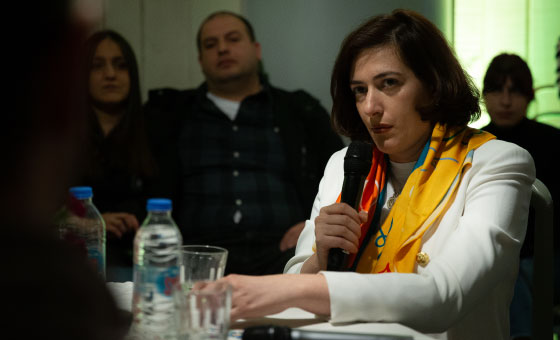 A person holding a microphone
Description automatically generated