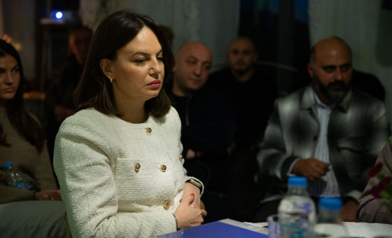 A person sitting at a table
Description automatically generated