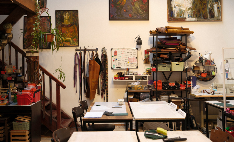 A room with a staircase and tables
Description automatically generated