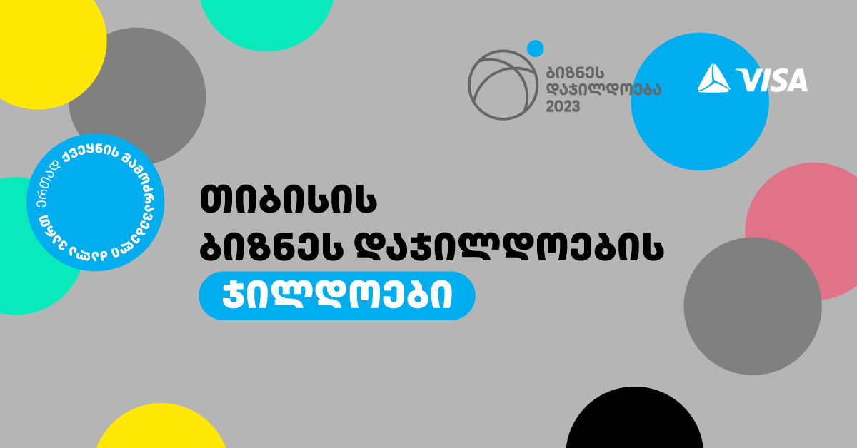 A grey background with black and blue circles and white text
Description automatically generated