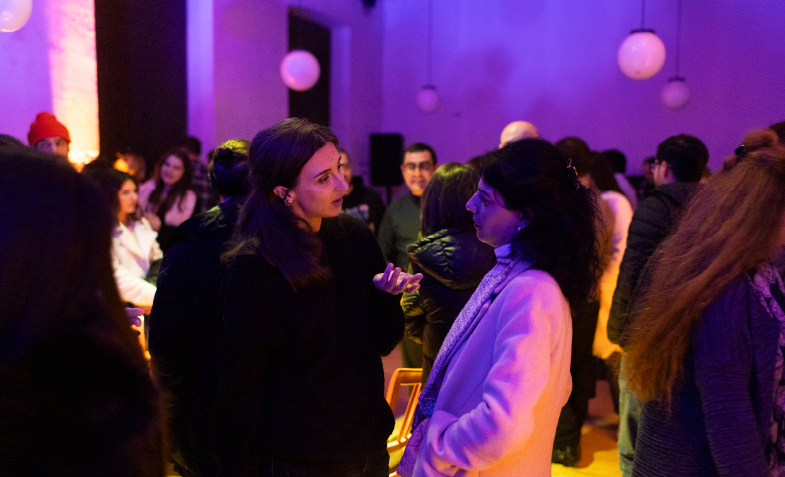 A group of people in a room
Description automatically generated