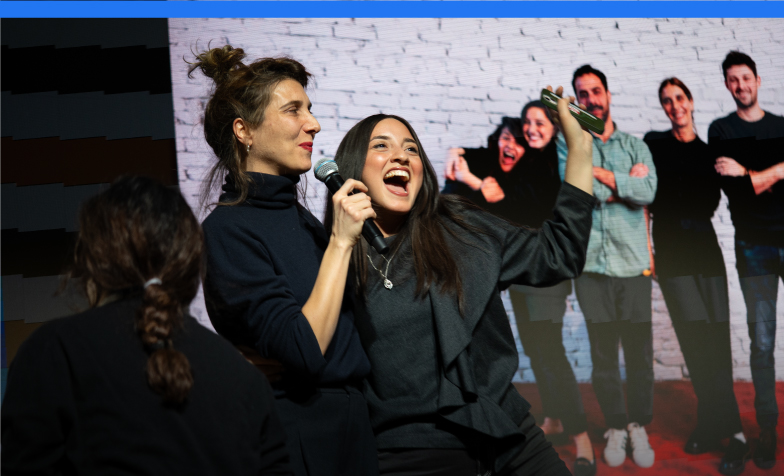 A person singing into a microphone
Description automatically generated